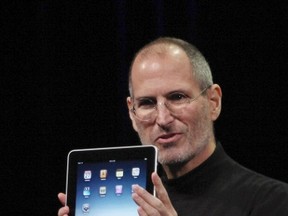 Apple Chief Executive Officer Steve Jobs holds the new iPad during the launch of Apple's new tablet computing device in San Francisco, California, in this January 27, 2010 file photograph. (REUTERS/Kimberly White/Files)
