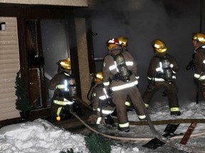 Firefighters battle a blaze in south Ottawa Thursday night, which left three people homeless and killed three family pets.