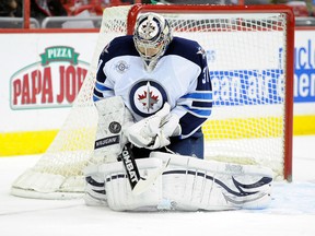 Pavelec makes a save against the Washington Capitals Thursday night. (GREG FIUME/AFP-Getty Images)