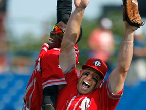 Ottawa Fat Cats' LaDale Hayes (left) and Rick Howroyd jump for joy after eliminating the London Majors in Game 5 of the Intercounty quarter-finals at Ottawa Stadium on Aug. 1, 2011. (DARREN BROWN/OTTAWA SUN)