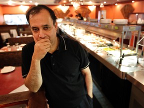 Buffet Moni Mahal owner Devan Chowdhury says he's been losing $15,000 in business each month since the Laurier Ave. bike lane was built in front of his restaurant. TONY CALDWELL/Ottawa Sun