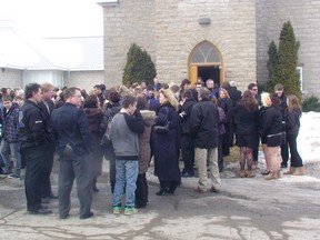 Family and friends of Tyler Kerr gather outside the church where his funeral was held Friday morning. (DANIELLE BELL/QMI AGENCY)