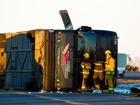 Firefighters investigate after a bus rolled over on Highway 28 near Redwater Friday. CODIE MCLACHLAN/EDMONTON SUN