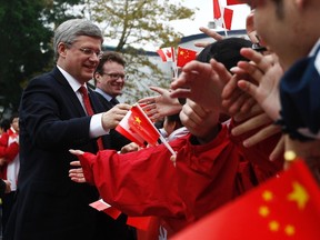 Prime Minister Stephen Harper greets students at the Huamei Bond International School in Guangzhou, February 10, 2012. (REUTERS/Chris Wattie)