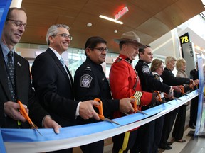 VIPs cuts the ribbon at the newly expanded terminal as it officially opens at the new U.S. terminal Saturday. PERRY MAH/EDMONTON SUN