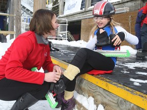 Emmanuelle Brindamour, 9, of the Toronto Speed Skating Club gets some tips and help with lacing up her skates from two-time Olympic gold medal speed skater, Catriona Le May Doan on Saturday at the Natrel skating rink, Harbourfront Centre, in Toronto. (Veronica Henri/Toronto Sun/QMI Agency)