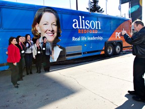 Supporters take photos in front of Premier Alison Redford's campaign bus, on scene for the PC campaign college at Radisson South in Edmonton, Alberta on Saturday, February 11, 2012.  AMBER BRACKEN/EDMONTON SUN/QMI AGENCY