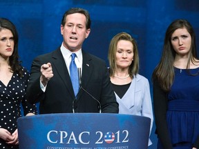 Republican U.S. presidential candidate Rick Santorum is flanked by his wife Karen (2nd R) and daughters Elizabeth (L) and Sarah (R) as he addresses the American Conservative Union’s annual Conservative Political Action Conference (CPAC) in Washington, February 10, 2012. REUTERS/Jonathan Ernst