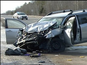 The shattered remains of a van after a head-on crash with a truck on Hwy. 148 near Quyon, Que.