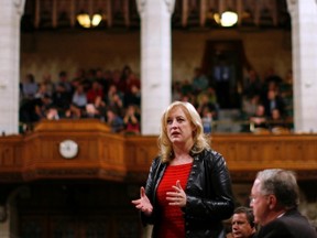 Canada's Labour Minister Lisa Raitt speaks during Question Period in the House of Commons on Parliament Hill in Ottawa October 21, 2011.      REUTERS/Chris Wattie