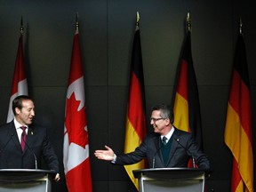 German Defence Minister Thomas de Maiziere takes part in a news conference with his Canadian counterpart Peter MacKay at the National Defence headquarters in Ottawa February 14, 2012.  (REUTERS/Chris Wattie)