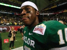 Baylor University quarterback Robert Griffin III walks off the field after playing against the Washington Huskies at the Valero Alamo Bowl in San Antonio, Tex., Dec. 29, 2011. (JOE MITCHELL/Reuters)