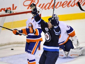Chris Thorburn celebrates his goal against New York Islanders Tuesday night. (FRED GREENSLADE/Reuters)