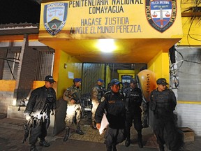 Army and police personnel stand guard at the National Prison of Comayagua where a deadly fire killed hundreds in central Honduras, the Central American country's prisons director said.    AFP PHOTO Orlando SIERRA