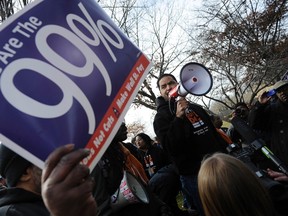 Protesters from the Occupy movement and labor unions gather outside the American Conservative Union’s annual Conservative Political Action Conference (CPAC) prior to an address by Republican U.S. presidential candidate Mitt Romney (R-MA) in Washington, February 10, 2012.  REUTERS/Jonathan Ernst