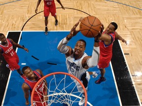 Magic centre Dwight Howard dunks over 76ers forward Lavoy Allen at the Amway Center in Orlando, Fla., Feb. 15, 2012. (FERNANDO MEDINA/NBAE via Getty Images/AFP)