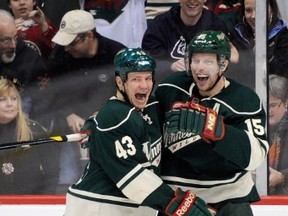 Minnesota Wild Warren Peters, left, congratulates Dany Heatley on a goal during the third period on Jan. 21, 2012 at Xcel Energy Center in St Paul, Minnesota. (Hannah Foslien/Getty Images/AFP)