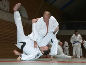 Russia's Prime Minister Vladimir Putin (top) attends a judo training session at Top Athletic School in St. Petersburg in this December 18, 2009 file photo.  REUTERS/Ria Novosti/Pool/Alexei Druzhinin