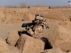 A file picture taken on February 15, 2010, shows a British soldier taking his position during a patrol in Qari Saheb village in the Helmand province of Afghanistan. Six British soldiers are missing and are believed to have been killed in Afghanistan, the Ministry of Defence said Wednesday March 7, 2012, taking the British death toll in the country to over 400  AFP PHOTO/Massoud HOSSAINI/FILES