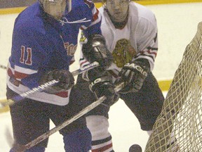 A member of the Transcona Railers (left) battles a Charleswood Hawks player for the puck. The Railers disbanded in 2011 but the MMJHL will be returning to Transcona next season, with a formal announcement expected on March 22. (Winnipeg Sun files)