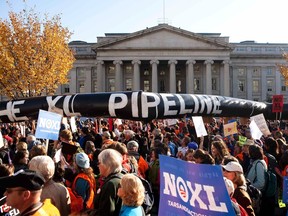 Demonstrators carry a giant mock pipeline while calling for the cancellation of the Keystone XL pipeline during a rally in Washington in this November 6, 2011 file photo. (REUTERS/Joshua Roberts/Files)