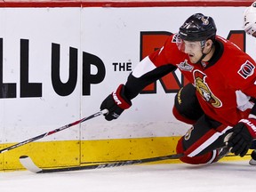 Ottawa Senator Nick Foligno is hauled down by Buffalo Sabre Robyn Regehr during third period action at Scotiabank Place in Ottawa. Saturday March 10,2012. (ERROL MCGIHON/THE OTTAWA SUN).