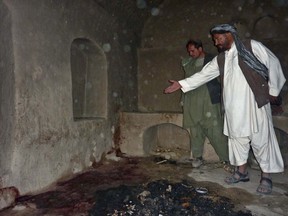 A villager points to a spot where a family was allegedly shot in their residence by a rogue US soldier in Alkozai village of Panjwayi district, Kandahar province on March 11, 2012. AFP PHOTO/MAMOON DURRANI