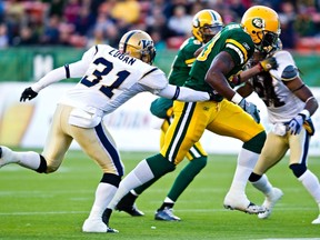 The Bombers are struggling to find non-imports like safety Ian Logan (seen tackling Edmonton's Jerome Messam, left). (CODIE MCLACHLAN/QMI AGENCY)