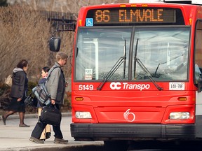 Passengers board an OC Transpo bus in downtown Ottawa during rush hour in Ottawa, March 15, 2012. (DARREN BROWN/QMI AGENCY)