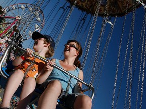 Joanne Willette and her son, Justin, go for a swing as the sun prepares to set on the last year of SuperEx at Lansdowne Park Sunday, August 29, 2010. 
 (Darren Brown/Ottawa Sun)