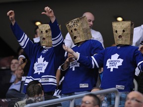 Toronto Maple Leafs fans wear paper bags over their heads during the third period of their NHL hockey game against the New York Islanders Tuesday night at the ACC. (REUTERS)