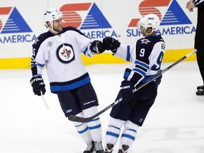 Tanner Glass (left) and Evander Kane talked hair after practice. (ERIC MILLER/Reuters)