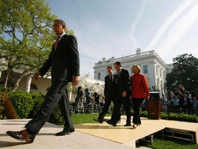 U.S. President Barack Obama walks off stage after introducing Dartmouth College President Jim Yong Kim (2nd R) as his nominee to be the next president of the World Bank, in the Rose Garden of the White House in Washington March 23, 2012.  REUTERS/Jonathan Ernst