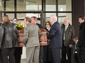 Pallbearers carry Erin Vance’s coffin from St. Isadore Roman Catholic Church on Saturday. The mother of two was struck and killed as she walked home from a St. Patrick’s Day outing in the early hours of March 18. (Matthew Usherwood/Ottawa Sun)