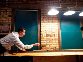 Republican presidential candidate and former U.S. Senator Rick Santorum plays a friendly game of shuffle board at Title Town Brewery in Green Bay, Wisconsin March 24, 2012.   REUTERS/Darren Hauck