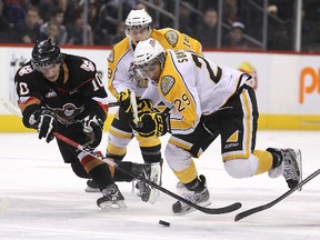 Brandon Wheat Kings Kevin Sundher tries to beat Calgary Hitmen Alex Gogolev (left) during WHL action Sunday at MTS Centre. The Wheaties won 4-1. (JASON HALSTEAD/Winnipeg Sun)