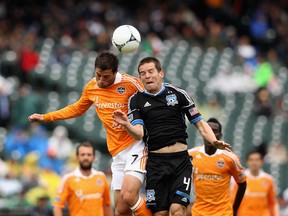 Colin Clark, of the Houston Dynamo, and Sam Cronin, of the San Jose Earthquakes, go for a ball last week at AT&T Park in San Francisco, California. (Ezra Shaw/Getty Images/AFP)