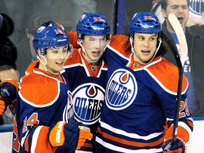 Ryan Jones, right, celebrates a goal with Oilers teammates Jordan Eberle, left, and Ryan Nugent-Hopkins against the Calgary Flames on March 16 in Edmonton. (DAN RIEDLHUBER/Reuters)