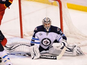 Jets goalie Ondrej Pavelec sits in the crease after giving up a goal Tuesday night in Florida. Pavelec isn’t thinking about negotiating a new contract just yet, but he will be an unrestricted free agent after the season.(RHONA WISE/Reuters)