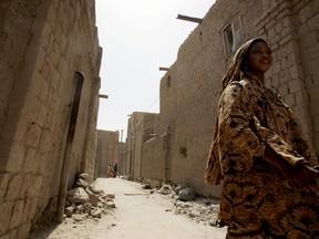 A woman walks in a street of the northwestern Malian city of Timbuktu. AFP PHOTO/ISSOUF SANOGO