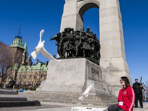 "Encounters With Canada" student Alli Halowski, from Lloydminster, Saskatchewan, releases doves at the conclusion of a ceremony marking the 95th Anniversary of the Battle of Vimy Ridge at the National war Memorial in Ottawa. Thursday April 5,2012. 
(ERROL MCGIHON/THE OTTAWA SUN)