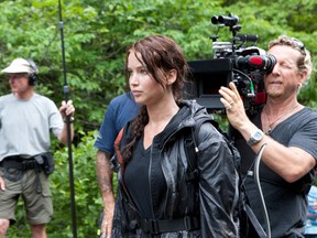 Jennifer Lawrence and a member of the film crew on The Hunger Games set.