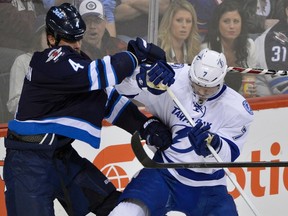 Winnipeg Jets’ defenceman Zach Bogosian (left) runs into Tampa Bay’s Brett Clark on Saturday night at MTS Centre. The Jets have some self-analysis ahead. (FRED GREENSLADE/Reuters)