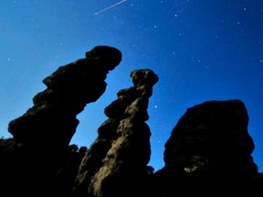 A meteor streaks past stars in the night sky. REUTERS/Ognen Teofilovski