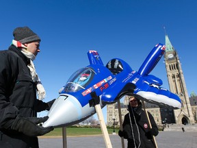 A small group from the Council of Canadians hold a protest against the F-35 fighter jet in front of Parliament Hill in Ottawa on March 26, 2012. (ANDRE FORGET/QMI AGENCY)