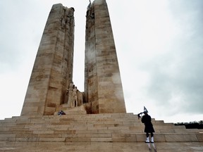 Matt Macisaac, Piper of the Royal Canadian Air Forces Band from Winnipeg Manitoba, plays with a pipe in front of the of the Canadian memorial, on April 09, 2012 in Vimy, northern France, during the commemoration ceremony marking the 95th anniversary of the Crete de Vimy battle during World War I. A total of 3,598 Canadian Corps troops were killed and 7,004 were wounded over four days of fighting as they seized control of the ridge from German soldiers. (AFP PHOTO PHILIPPE HUGUEN)