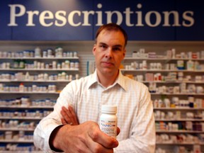 Prescription Shop pharmacist Mark Kearney at Carleton University holds up a bottle of OxyNeo, which is supposed to be less attractive as a target for theft to drug addicts.