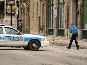 A police cadet guards the scene hours after a 20-year-old man was stabbed in a fracas outside the Republic nightclub in Winnipeg's Exchange District early on Sunday, April 15, 2012. (Courtesy Howard Wong)