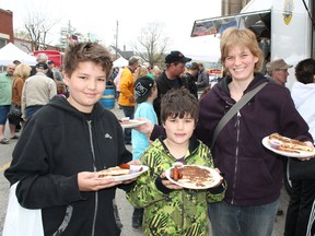 Keegan Runge, 9, his brother Jarrett, 7, and mother Julie of Brantford show off the pancakes breakfasts served up at the Paris Lions Club Maple Syrup Festival in downtown Paris, Ontario on Saturday, April 14, 2012. MICHAEL PEELING/THE PARIS STAR/QMI AGENCY