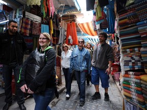 Tourists stroll through the souks of the medina of Tunis on April 16, 2012. Tourism officials met on April 16 on Tunisia's Djerba island -- a holidaymakers' magnet before the Arab Spring uprisings -- to revive the Mediterranean as the world's top travel destination.  AFP PHOTO/FETHI BELAID